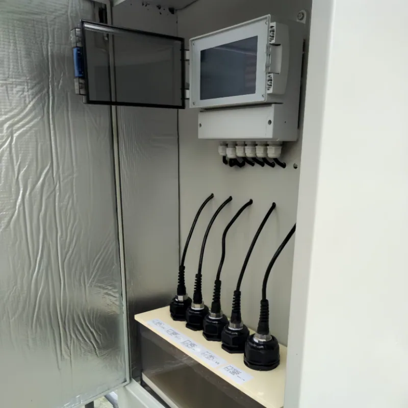 Open water-quality monitoring cabinet showing controller, wiring, and a bank of sensor probes